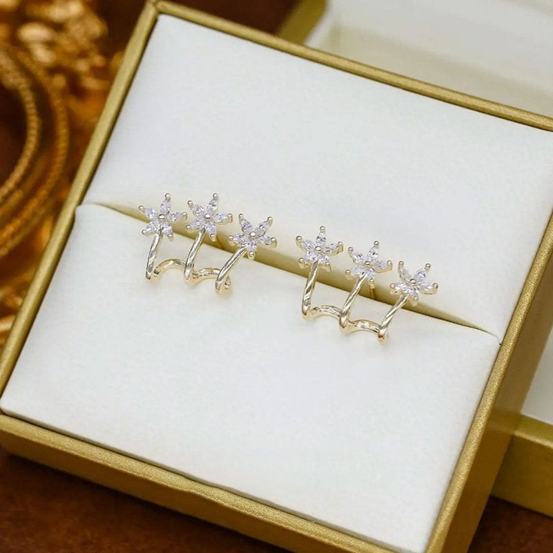 Drie bloem een doorboorde oorbellen